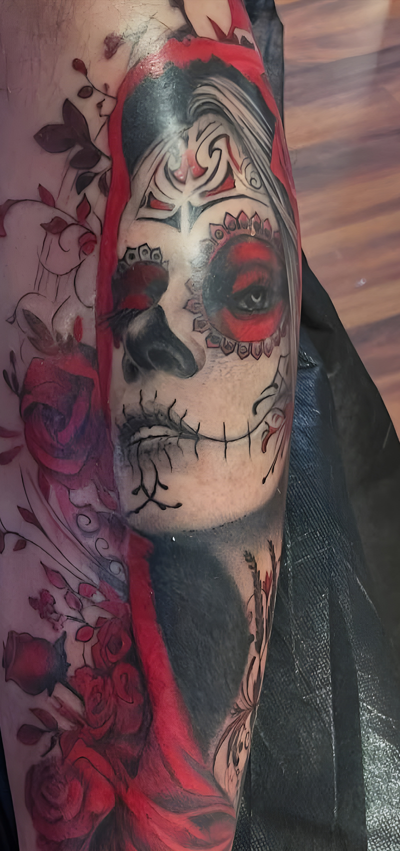 Color realism Day of the Dead sugar skull tattoo with red roses and black shading by Bullet’s Ink in Mt Airy, Maryland.