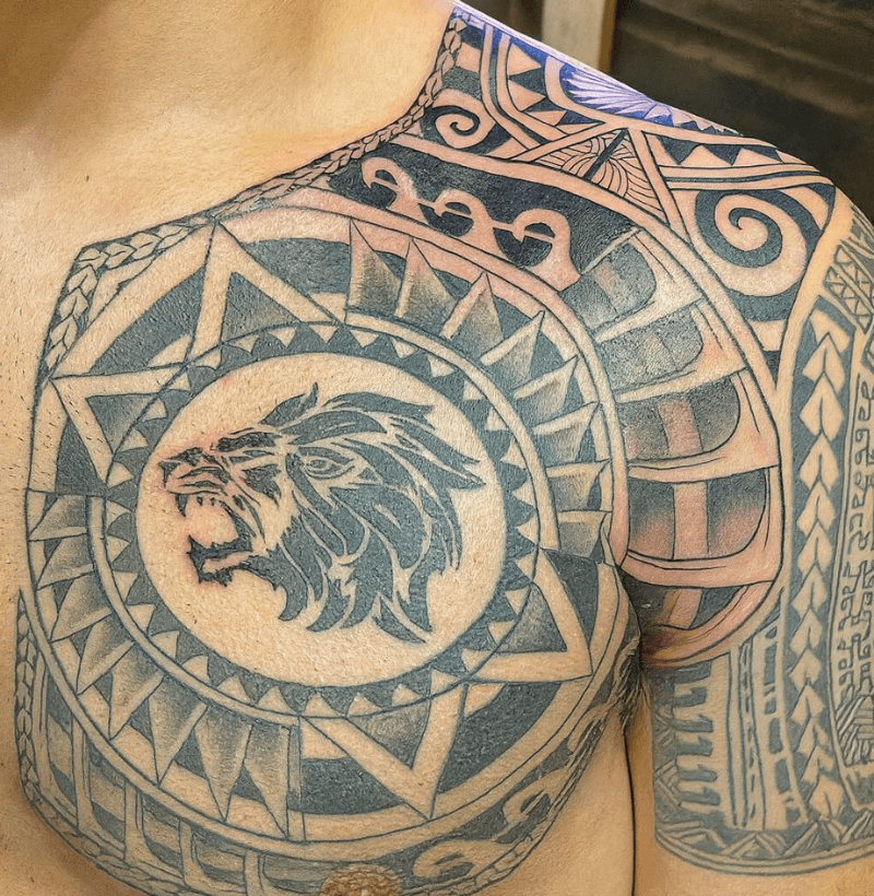 Polynesian tribal lion chest tattoo with bold geometric lines and black ink, created by Bullet’s Ink in Mt Airy, Maryland.