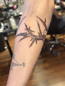 Black and grey crown of thorns tattoo wrapped around arm by Robyn at Bullet’s Ink in Mount Airy MD