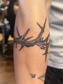 Black and grey crown of thorns tattoo wrapped around arm by Robyn at Bullet’s Ink in Mount Airy MD