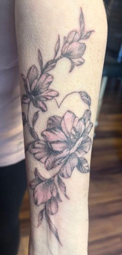 Pink floral sleeve tattoo by Robyn Hardman at Bullet’s Ink