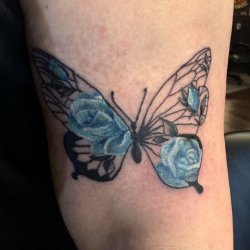 Butterfly and blue roses tattoo by Robyn Hardman at Bullet’s Ink in Mt. Airy, MD