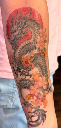 Color dragon sleeve tattoo by Robyn Hardman at Bullet’s Ink
