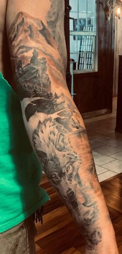 Color mountain wolf sleeve tattoo by Robyn Hardman at Bullet’s Ink in Mt. Airy, MD