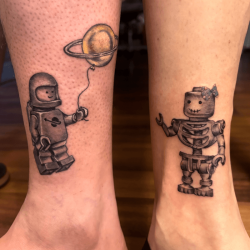 Lego figures tattoo on ankles by Robyn Hardman at Bullet’s Ink
