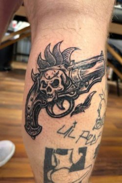 Skull gun tattoo by Robyn Hardman at Bullet’s Ink